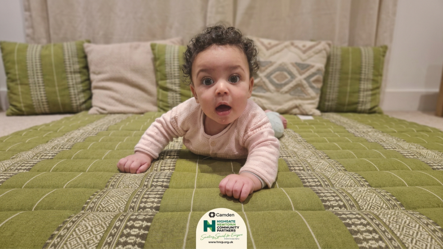 Baby looking at camera - logo